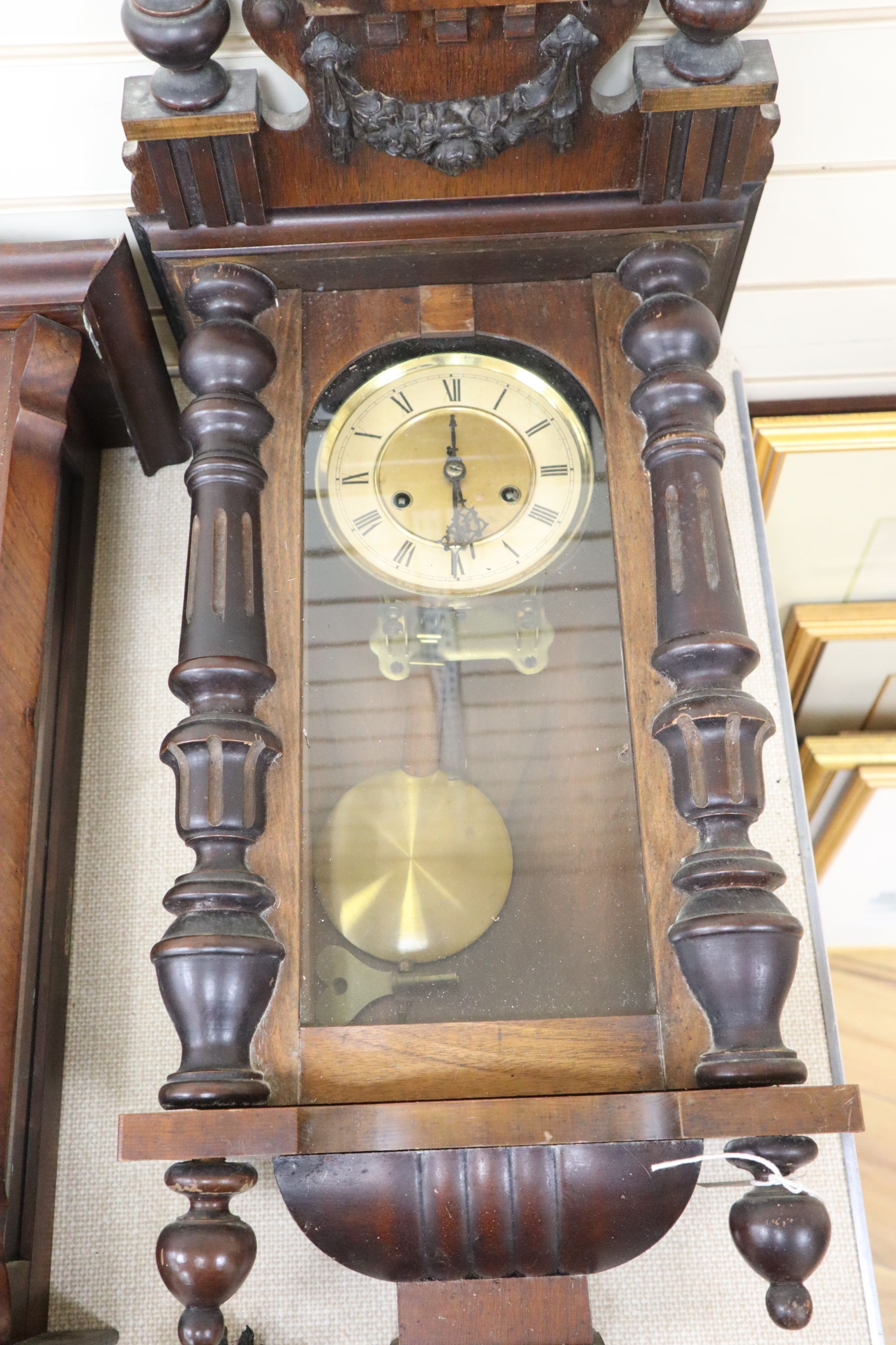 A walnut Vienna regulator with enamelled Roman dial and another regulator with carved pediment, largest 75cm